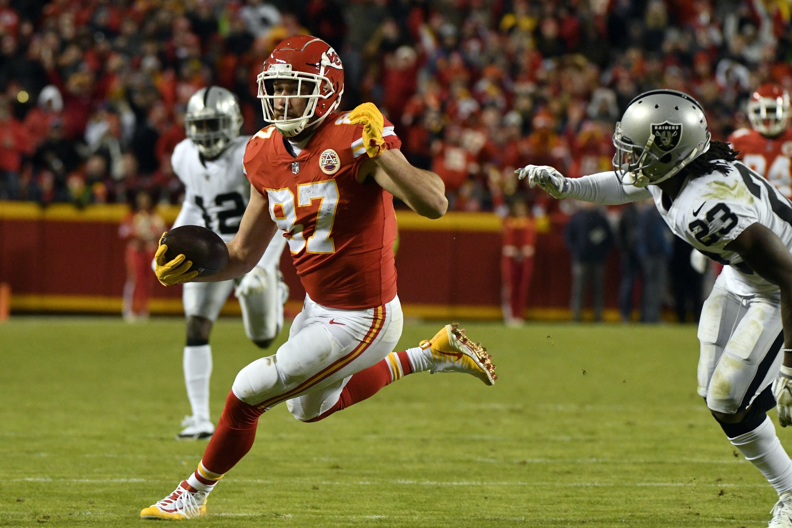 Kansas City Chiefs tight end Travis Kelce (87) carries the ball during the second half of an NFL football game against the Oakland Raiders in Kansas City, Mo., Sunday, Dec. 30, 2018. Travis Kelce surpassed Rob Gronkowski for the most receiving yards by a tight end in a single season in NFL history. (AP Photo/Ed Zurga)