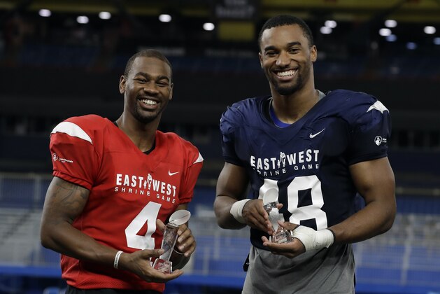 East Wide receiver Terry Godwin II (4), of Georgia, and West linebacker Justin Hollins (48), of Oregon, pose with their trophies after being named MVP's of the East-West Shrine football game Saturday, Jan. 19, 2019, in St. Petersburg, Fla. (AP Photo/Chris O'Meara)