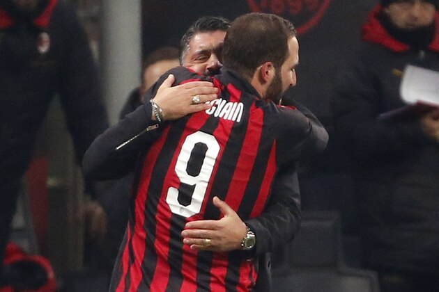 AC Milan's Gonzalo Higuain, right, celebrates with AC Milan coach Gennaro Gattuso after scoring his side's second goal during a Serie A soccer match between AC Milan and Spal, at the San Siro stadium, Saturday, Dec. 29, 2018. (AP Photo/Antonio Calanni)