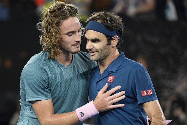 Greece's Stefanos Tsitsipas, left, is congratulated by Switzerland's Roger Federer after winning their fourth round match at the Australian Open tennis championships in Melbourne, Australia, Sunday, Jan. 20, 2019. (AP Photo/Andy Brownbill)