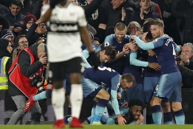 Tottenham Hotspur's players celebrate a late winning goal from Harry Winks during the English Premier League football match between Fulham and Tottenham Hotspur at Craven Cottage in London on January 20, 2019. - Tottenham won the game 2-1. (Photo by Adrian DENNIS / AFP) / RESTRICTED TO EDITORIAL USE. No use with unauthorized audio, video, data, fixture lists, club/league logos or 'live' services. Online in-match use limited to 120 images. An additional 40 images may be used in extra time. No video emulation. Social media in-match use limited to 120 images. An additional 40 images may be used in extra time. No use in betting publications, games or single club/league/player publications. /         (Photo credit should read ADRIAN DENNIS/AFP/Getty Images)