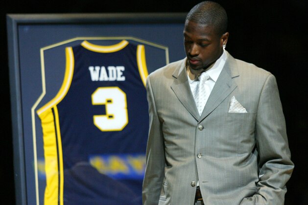 Miami Heat and former Marquette player Dwyane Wade takes a moment during a half time presentation to retire his number as Marquette takes on Providence in a college basketball game Saturday Feb. 3, 2007 in Milwaukee.    (AP Photo/Darren Hauck)