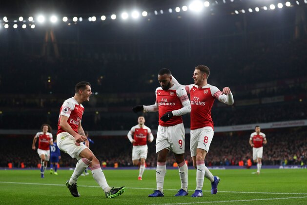 LONDON, ENGLAND - JANUARY 19: Alexandre Lacazette of Arsenal celebrates scoring his teams first goal with Granit Xhaka and Aaron Ramsey during the Premier League match between Arsenal FC and Chelsea FC at Emirates Stadium on January 19, 2019 in London, United Kingdom. (Photo by Catherine Ivill/Getty Images)