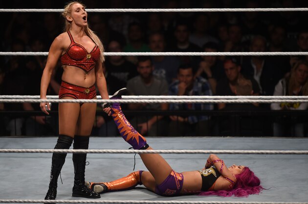 WWE wrestling stars Sasha Bank (R) and Charlotte Flair (L) fight during a WWE (World Wrestling Entertainment) women's fight at the Olympic hall in Munich, southern Germany, on November 3, 2016.  / AFP / CHRISTOF STACHE        (Photo credit should read CHRISTOF STACHE/AFP/Getty Images)