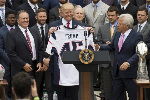 US President Donald Trump holds a jersey given to him by New England Patriots owner Robert Kraft (R) and head coach Bill Belichick (L) alongside members of the team during a ceremony honoring them as 2017 Super Bowl Champions on the South Lawn of the White House in Washington, DC, April 19, 2017. / AFP PHOTO / SAUL LOEB        (Photo credit should read SAUL LOEB/AFP/Getty Images)