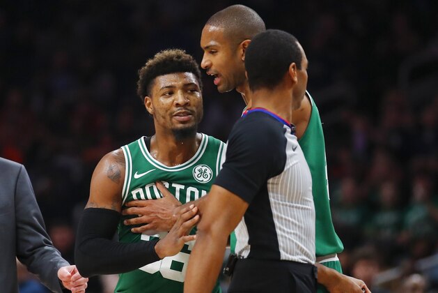 Boston Celtics guard Marcus Smart (36) is restrained by center Al Horford during the second half of the team's NBA basketball game against the Atlanta Hawks on Saturday, Jan. 19, 2019, in Atlanta. (AP Photo/Todd Kirkland)