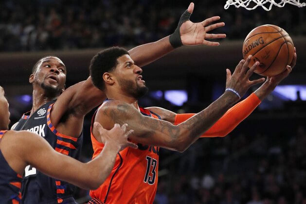 New York Knicks forward Noah Vonleh (32) defends as Oklahoma City Thunder forward Paul George (13) bobbles the ball beneath the Thunder's basket during the first half of an NBA basketball game, Monday, Jan. 21, 2019, in New York. (AP Photo/Kathy Willens)