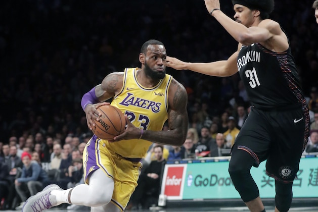 Los Angeles Lakers' LeBron James (23) drives past Brooklyn Nets' Jarrett Allen (31) during the first half of an NBA basketball game Tuesday, Dec. 18, 2018, in New York. (AP Photo/Frank Franklin II)