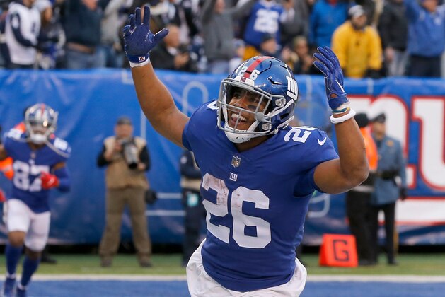 EAST RUTHERFORD, NJ - DECEMBER 30:  (NEW YORK DAILIES OUT)   Saquon Barkley #26 of the New York Giants celebrates a touchdown against the Dallas Cowboys on December 30, 2018 at MetLife Stadium in East Rutherford, New Jersey. The Cowboys defeated the Giants 36-35.  (Photo by Jim McIsaac/Getty Images)