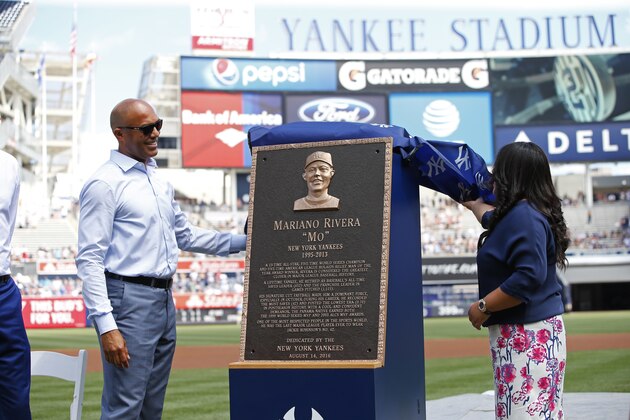 Former New York Yankees closer Mariano Rivera, left, and his wife, Clara, unveil his Monument Park plaque before a baseball game Sunday, Aug. 14, 2016, at Yankee Stadium in New York. (AP Photo/Rich Schultz/Pool)