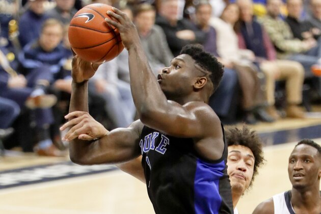 Duke's Zion Williamson, left, is fouled by Pittsburgh's Kene Chukwuka as he shoots during the second half of an NCAA college basketball game, Tuesday, Jan. 22, 2019, in Pittsburgh. (AP Photo/Keith Srakocic)