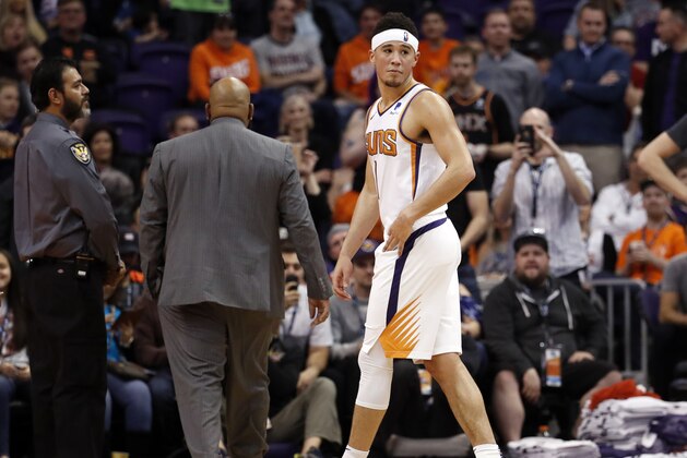 Phoenix Suns guard Devin Booker (1) leaves the game after being ejected during the second half of an NBA basketball game against the Minnesota Timberwolves, Tuesday, Jan. 22, 2019, in Phoenix. (AP Photo/Matt York)