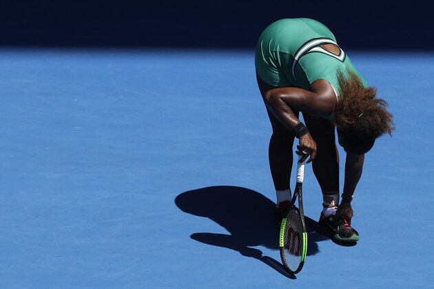 United States' Serena Williams grabs at her ankle during her quarterfinal loss to Karolina Pliskova of the Czech Republic at the Australian Open tennis championships in Melbourne, Australia, Wednesday, Jan. 23, 2019. (AP Photo/Mark Schiefelbein)