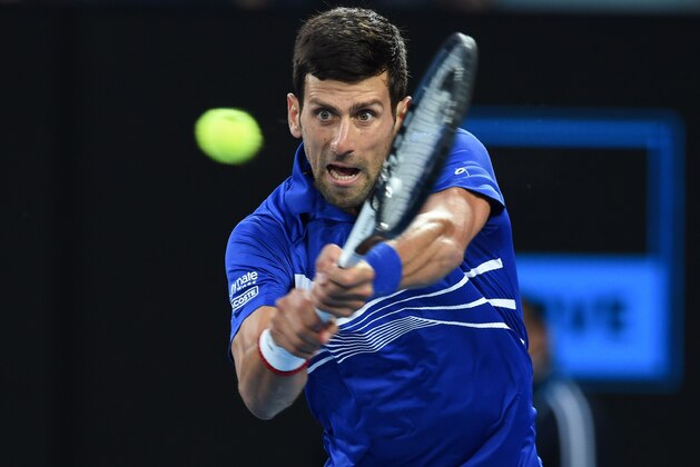 Serbia's Novak Djokovic hits a return against Japan's Kei Nishikori during their men's singles quarter-final match on day ten of the Australian Open tennis tournament in Melbourne on January 23, 2019. (Photo by Greg Wood / AFP) / -- IMAGE RESTRICTED TO EDITORIAL USE - STRICTLY NO COMMERCIAL USE --        (Photo credit should read GREG WOOD/AFP/Getty Images)