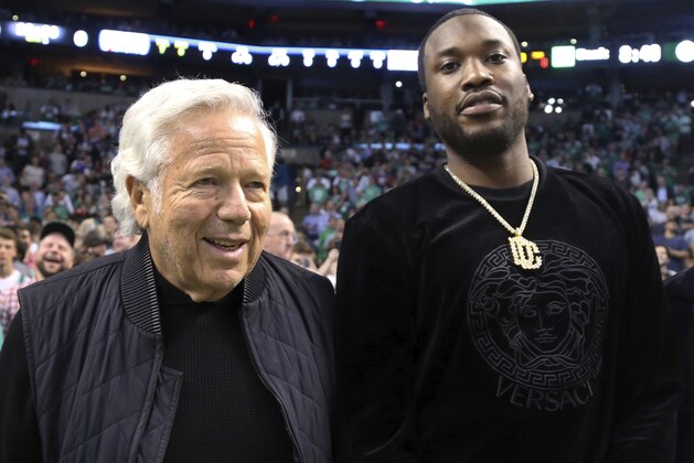 Rapper Meek Mill, right, stands with New England Patriots football team owner Robert Kraft at their seats for Game 2 of an NBA basketball second-round playoff series between the Boston Celtics and the Philadelphia 76ers, Thursday, May 3, 2018, in Boston. (AP Photo/Elise Amendola)