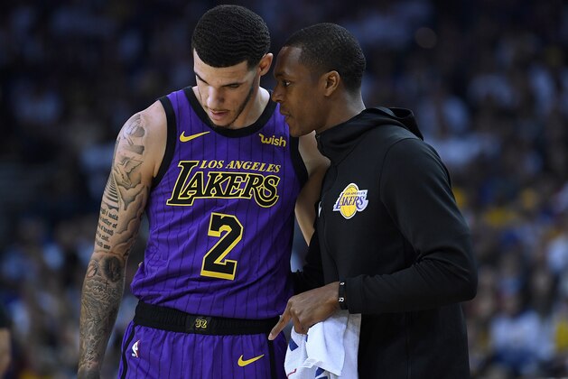 OAKLAND, CA - DECEMBER 25: Lonzo Ball #2 of the Los Angeles Lakers listens to teammate Rajon Rondo #9 against the Golden State Warriors during the first half of their NBA Basketball game at ORACLE Arena on December 25, 2018 in Oakland, California. NOTE TO USER: User expressly acknowledges and agrees that, by downloading and or using this photograph, User is consenting to the terms and conditions of the Getty Images License Agreement. (Photo by Thearon W. Henderson/Getty Images) OAKLAND, CA - DECEMBER 25: Lonzo Ball #2 of the Los Angeles Lakers listens to teammate Rajon Rondo #9 against the Golden State Warriors during the first half of their NBA Basketball game at ORACLE Arena on December 25, 2018 in Oakland, California. NOTE TO USER: User expressly acknowledges and agrees that, by downloading and or using this photograph, User is consenting to the terms and conditions of the Getty Images License Agreement. (Photo by Thearon W. Henderson/Getty Images)