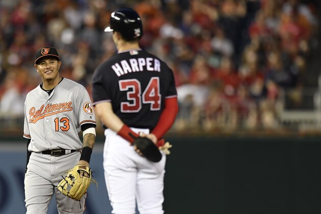 WASHINGTON, DC - JUNE 19: Bryce Harper #34 of the Washington Nationals talks with Manny Machado #13 of the Baltimore Orioles after hitting a RBI double in the fifth inning at Nationals Park on June 19, 2018 in Washington, DC. (Photo by Patrick McDermott/Getty Images)