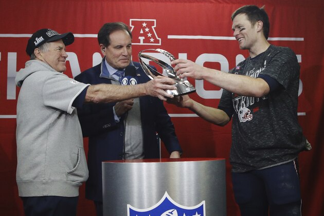New England Patriots head coach Bill Belichick, left, hands off the championship trophy to quarterback Tom Brady after defeating the Kansas City Chiefs in the AFC Championship NFL football game, Sunday, Jan. 20, 2019, in Kansas City, Mo. (AP Photo/Charlie Riedel)