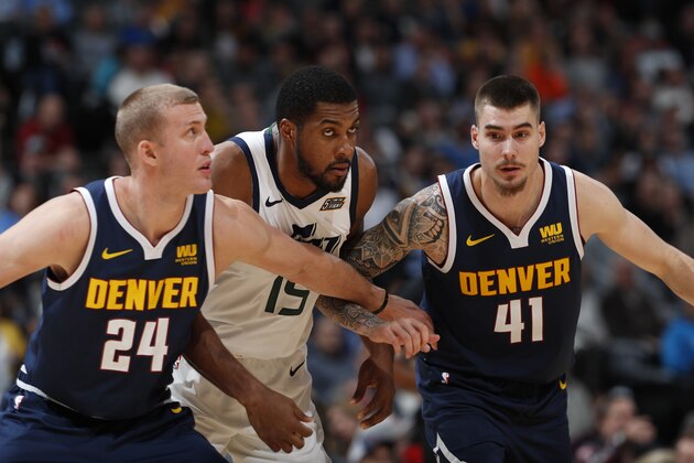 Utah Jazz forward Derrick Favors (15), center, Denver Nuggets forward Mason Plumlee (24) and Denver Nuggets forward Juan Hernangomez (41) in the second half of an NBA basketball game Saturday, Nov. 3, 2018, in Denver. The Nuggets won 103-88. (AP Photo/David Zalubowski)