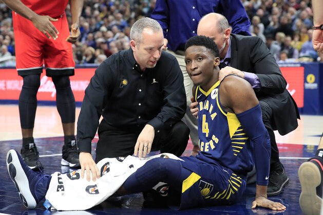 INDIANAPOLIS, INDIANA - JANUARY 23:  Victor Oladipo #4 of the Indiana Pacers is attended to by medical staff after being injured in the second quarter of the game against the Toronto Raptors  at Bankers Life Fieldhouse on January 23, 2019 in Indianapolis, Indiana. (Photo by Andy Lyons/Getty Images)