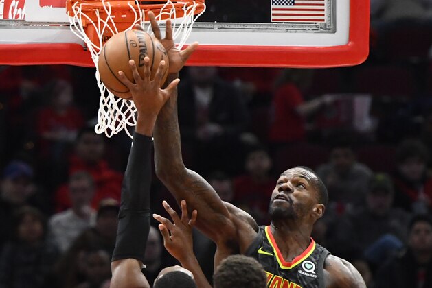 Atlanta Hawks center Dewayne Dedmon (14) defends against Chicago Bulls guard Kris Dunn (32) during the second half of an NBA basketball game Wednesday Jan. 23, 2019, in Chicago. (AP Photo/Matt Marton)