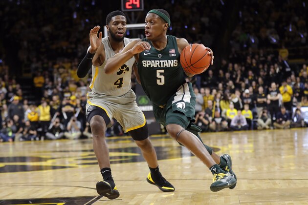 Michigan State guard Cassius Winston (5) drives past Iowa guard Isaiah Moss (4) during the first half of an NCAA college basketball game Thursday, Jan. 24, 2019, in Iowa City, Iowa. (AP Photo/Charlie Neibergall)