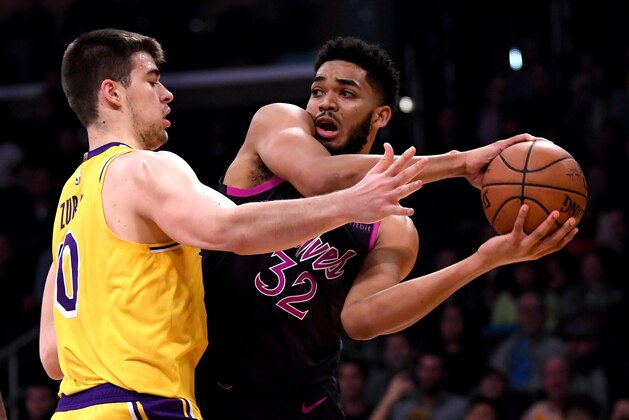 LOS ANGELES, CALIFORNIA - JANUARY 24:  Karl-Anthony Towns #32 of the Minnesota Timberwolves looks to pass in front of Ivica Zubac #40 of the Los Angeles Lakers during the first half at Staples Center on January 24, 2019 in Los Angeles, California. (Photo by Harry How/Getty Images)