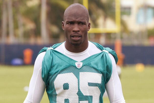 FILE - This June 19, 2012 file photo shows Miami Dolphins' Chad Ochocinco, who recently changed his name back to Chad Johnson, talking to reporters in Davie, Fla. The Dolphins terminated the six-time Pro Bowl receiver's contract about 24 hours after he was arrested in a domestic battery case involving his wife. Johnson was released from jail on $2,500 bond Sunday, Aug. 12, 2012,  after his wife accused him of head-butting her during an argument in front of their home. (AP Photo/J Pat Carter, File)
