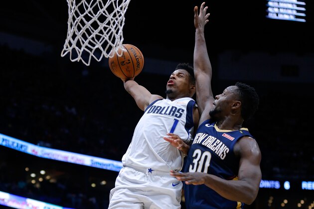 NEW ORLEANS, LOUISIANA - DECEMBER 28: Dennis Smith Jr. #1 of the Dallas Mavericks dunks on Julius Randle #30 of the New Orleans Pelicans during the second half at the Smoothie King Center on December 28, 2018 in New Orleans, Louisiana. NOTE TO USER: User expressly acknowledges and agrees that, by downloading and or using this photograph, User is consenting to the terms and conditions of the Getty Images License Agreement.  (Photo by Jonathan Bachman/Getty Images)
