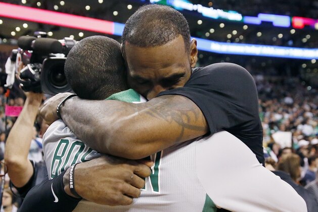 Cleveland Cavaliers' LeBron James, right, hugs Boston Celtics' Kyrie Irving following an NBA basketball game in Boston, Sunday, Feb. 11, 2018. The Cavaliers won 121-99. (AP Photo/Michael Dwyer)
