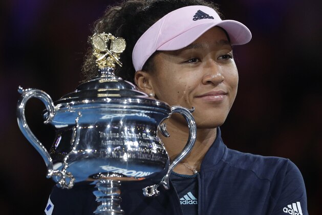 Japan's Naomi Osaka holds her trophy after defeating Petra Kvitova of the Czech Republic during the women's singles final at the Australian Open tennis championships in Melbourne, Australia, Saturday, Jan. 26, 2019. (AP Photo/Mark Schiefelbein)
