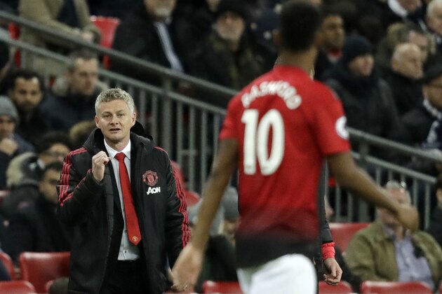 Manchester United caretaker manager Ole Gunnar Solskjaer, left, celebrates after Manchester United's Marcus Rashford, right, scored his side's first goal during the English Premier League soccer match between Tottenham Hotspur and Manchester United at Wembley stadium in London, England, Sunday, Jan. 13, 2019. (AP Photo/Matt Dunham)