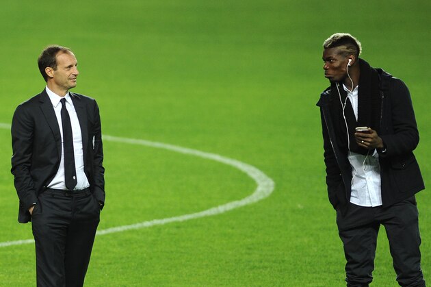 Juventus's French midfielder Paul Pogba (R) speaks with Juventus's coach Italian Massimiliano Allegri (L) at the Ramon Sanchez Pizjuan in Sevilla on December 7, 2015, on the eve of the UEFA Champions League Group D football match Sevilla FC vs Juventus. AFP PHOTO/ CRISTINA QUICLER / AFP / CRISTINA QUICLER (Photo credit should read CRISTINA QUICLER/AFP/Getty Images) Juventus's French midfielder Paul Pogba (R) speaks with Juventus's coach Italian Massimiliano Allegri (L) at the Ramon Sanchez Pizjuan in Sevilla on December 7, 2015, on the eve of the UEFA Champions League Group D football match Sevilla FC vs Juventus. AFP PHOTO/ CRISTINA QUICLER / AFP / CRISTINA QUICLER (Photo credit should read CRISTINA QUICLER/AFP/Getty Images)