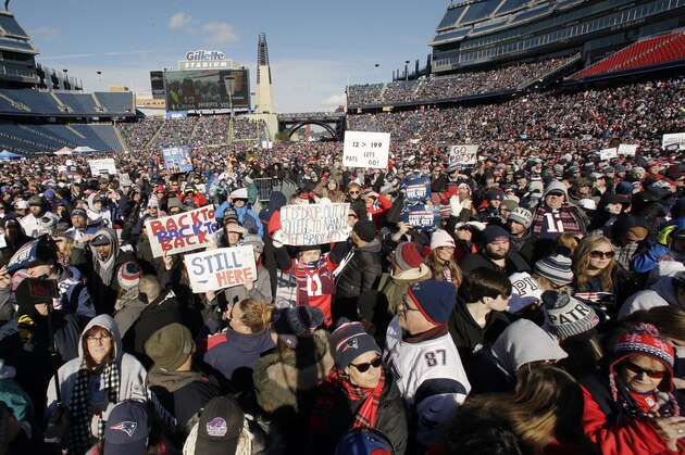 New England Patriots fans hold placards and cheer during an NFL football Super Bowl send-off rally for the team, Sunday, Jan. 27, 2019, in Foxborough, Mass. The Los Angeles Rams are to play the Patriots in Super Bowl on Feb. 3, in Atlanta, Ga. (AP Photo/Steven Senne)