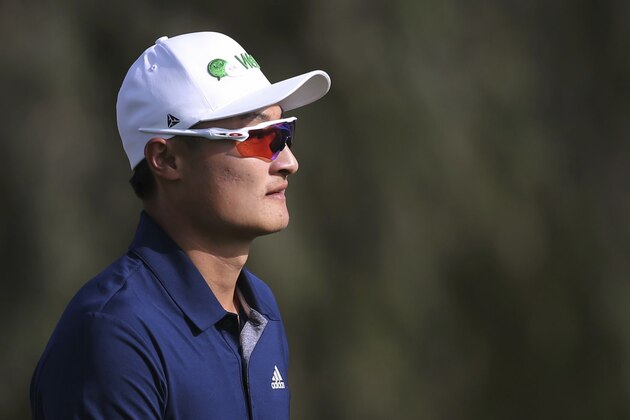 Haotong Li of China walks on the 14th hole during round three of the Dubai Desert Classic golf tournament in Dubai, United Arab Emirates, Saturday, Jan. 26, 2019. (AP Photo/Kamran Jebreili)