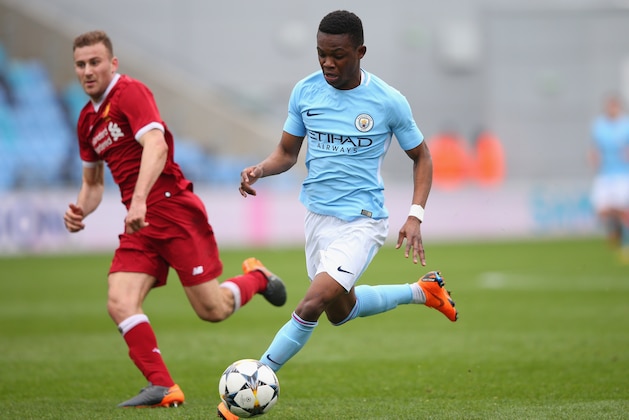MANCHESTER, ENGLAND - MARCH 14:  Rabbi Matondo of Manchester City beats Herbie Kane of Liverpool during the UEFA Youth League Quarter-Final match between Manchester City and Liverpool at Manchester City Football Academy on March 14, 2018 in Manchester, England.  (Photo by Alex Livesey/Getty Images)