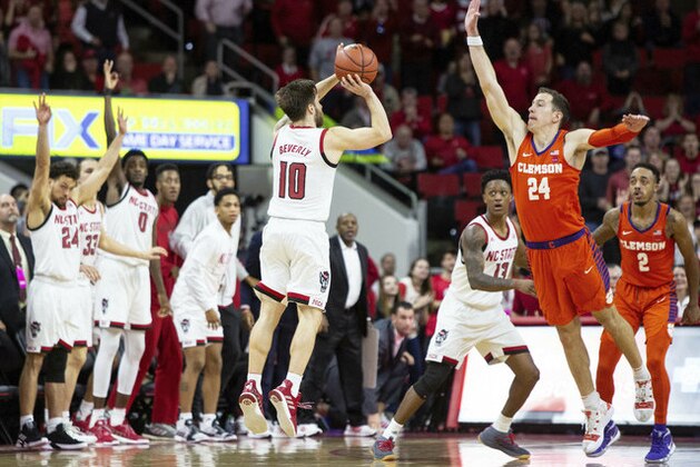 North Carolina State's Braxton Beverly (10) hits the game-winning three-point shot over Clemson's David Skara (24) at the conclusion of an NCAA college basketball game in Raleigh, N.C., Saturday, Jan. 26, 2019. NC State won 69-67. (AP Photo/Ben McKeown)