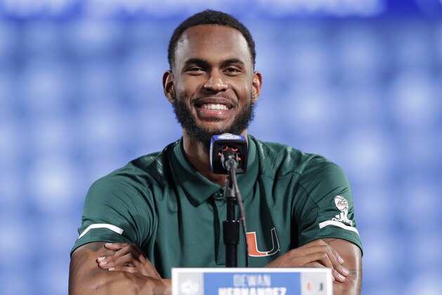 FILE - In this Oct. 24, 2018, file photo, Miami's Dewan Hernandez speaks to the media during a news conference at the Atlantic Coast Conference NCAA college basketball media day in Charlotte, N.C. Miami Hurricanes coach Jim Larranaga says junior forward Dewan Hernandez deserves to be declared eligible by the NCAA because he unwittingly became entangled in a college basketball corruption case when he was duped by an AAU coach. Larranaga spoke at length about Hernandez’s status for the first time Friday, Jan. 18, 2019, as the school awaited an NCAA ruling. (AP Photo/Chuck Burton)