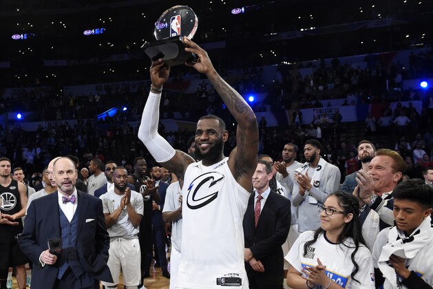 Team LeBron's LeBron James, of the Cleveland Cavaliers, holds the MVP trophy after his team defeated Team Stephen at the NBA All-Star basketball game, Sunday, Feb. 18, 2018, in Los Angeles. Team LeBron won 148-145. (AP Photo/Chris Pizzello)