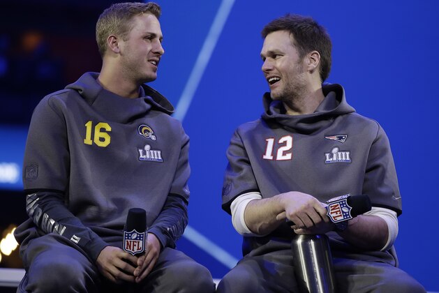 Los Angeles Rams' Jared Goff talks to New England Patriots' Tom Brady during Opening Night for the NFL Super Bowl 53 football game Monday, Jan. 28, 2019, in Atlanta. (AP Photo/Matt Rourke)