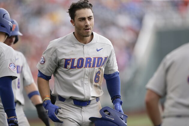 Florida's Jonathan India returns to the dugout after hitting a three-run home run in the sixth inning of an NCAA College World Series baseball elimination game against Texas in Omaha, Neb., Tuesday, June 19, 2018. Florida won 6-1. (AP Photo/Nati Harnik)