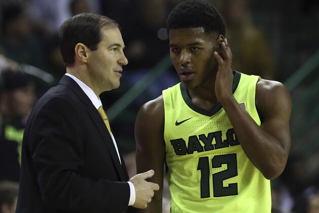 Baylor head coach Scott Drew talks with Baylor guard Jared Butler (12) in the first half of an NCAA college basketball game against Kansas, Saturday, Jan. 12, 2019, in Waco, Texas. (AP Photo/Jerry Larson)