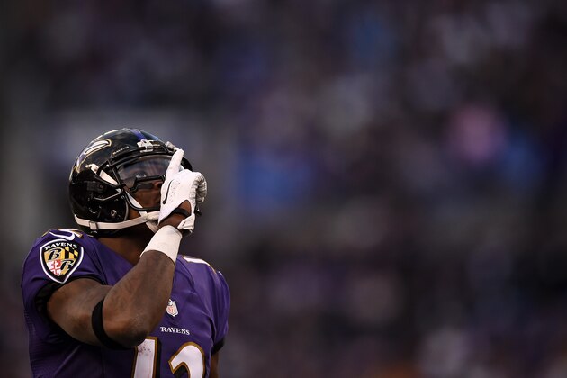 BALTIMORE, MD - NOVEMBER 30: Wide receiver Jacoby Jones #12 of the Baltimore Ravens looks to the sky before a kickoff return in the fourth quarter against the San Diego Chargers at M&T Bank Stadium on November 30, 2014 in Baltimore, Maryland. The San Diego Chargers won, 34-33. (Photo by Patrick Smith/Getty Images)