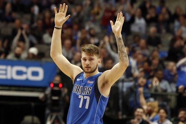 Dallas Mavericks forward Luka Doncic of Germany raises his arms during the second half of an NBA basketball game in Dallas, Tuesday, Jan. 22, 2019. (AP Photo/LM Otero)