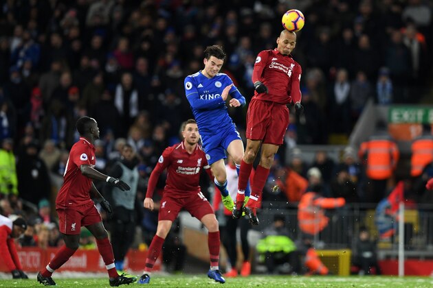 Liverpool's Brazilian midfielder Fabinho (R) heads the ball under pressure from Leicester City's English defender Ben Chilwell (C) during the English Premier League football match between Liverpool and Leicester City at Anfield in Liverpool, north west England on January 30, 2019. (Photo by Paul ELLIS / AFP) / RESTRICTED TO EDITORIAL USE. No use with unauthorized audio, video, data, fixture lists, club/league logos or 'live' services. Online in-match use limited to 120 images. An additional 40 images may be used in extra time. No video emulation. Social media in-match use limited to 120 images. An additional 40 images may be used in extra time. No use in betting publications, games or single club/league/player publications. /         (Photo credit should read PAUL ELLIS/AFP/Getty Images)
