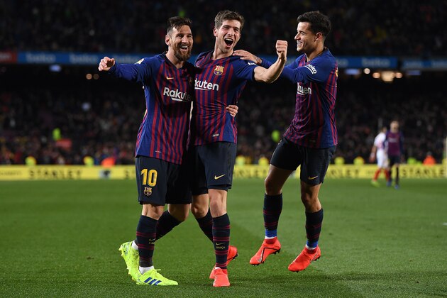 BARCELONA, SPAIN - JANUARY 30:  Philippe Coutinho (R) of Barcelona celebrates scoring his sides third goal alongside Sergi Roberto (C) and Lionel Messi during the Copa del Rey Quarter Final  second leg match between FC Barcelona and Sevilla FC at Nou Camp on January 30, 2019 in Barcelona, Spain. (Photo by David Ramos/Getty Images)