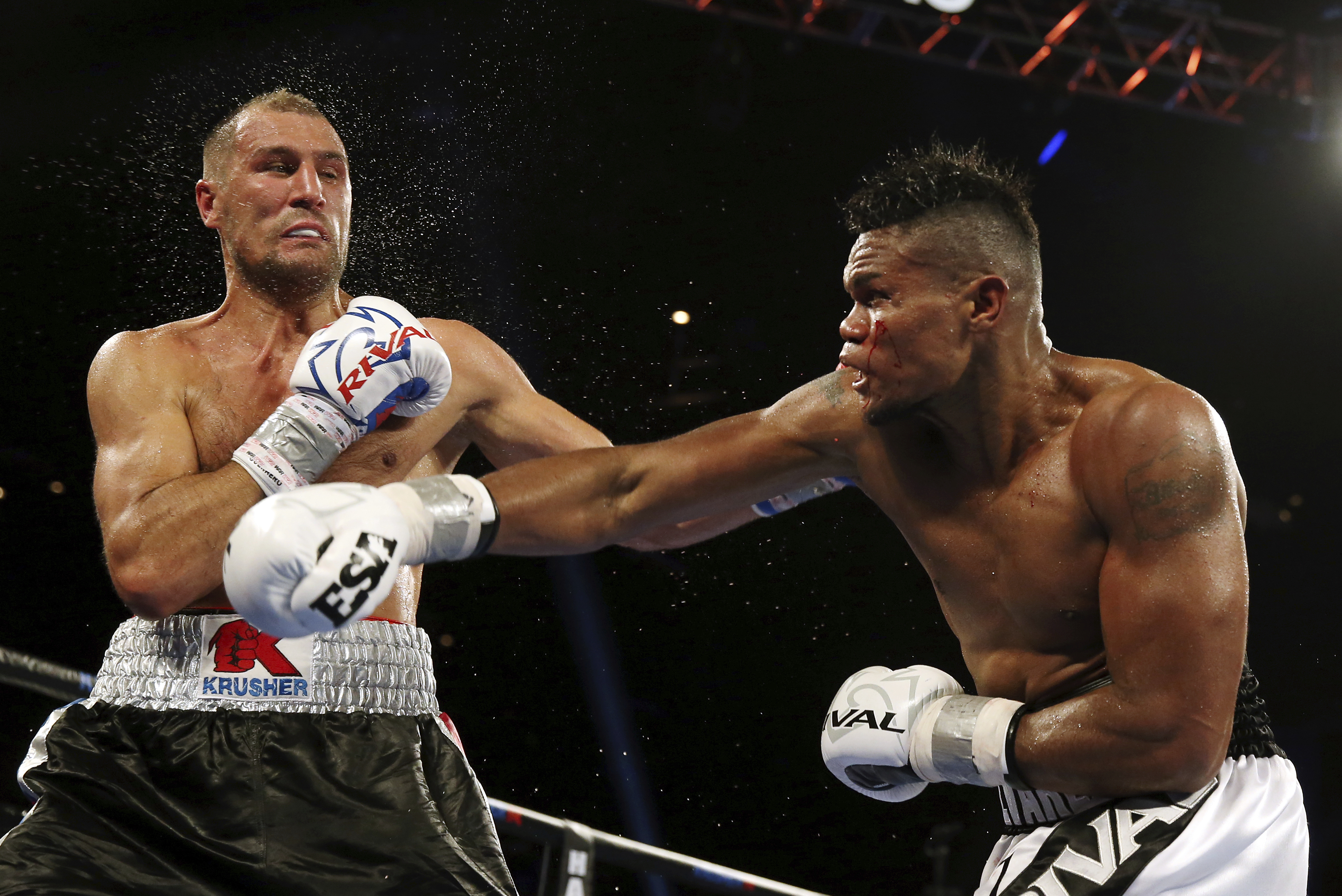 Eleider Alvarez, right, of Colombia, connects a punch to Sergey Kovalev, left, of Russia, during the seventh round of their 175-pound boxing bout Saturday, Aug. 4, 2018, in Atlantic City, N.J. Alvarez won by knockout in the seventh round. (AP Photo/Mel Evans)