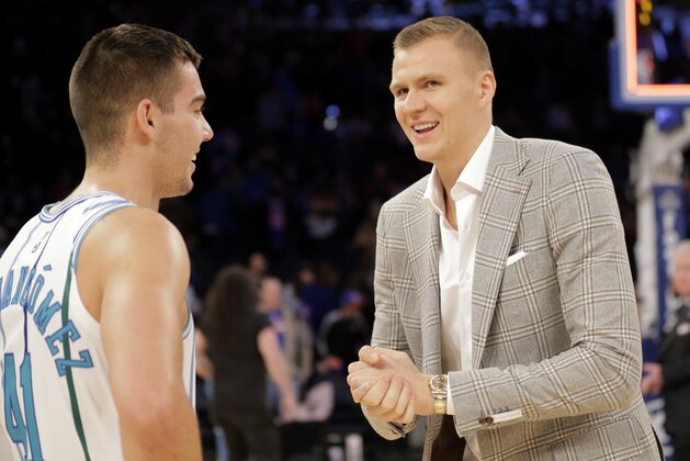 New York Knicks' Kristaps Porzingis, right, talks with Charlotte Hornets' Willy Hernangomez after the NBA basketball game, Sunday, Dec. 9, 2018, in New York. The Hornets defeated the Knicks 119-107. (AP Photo/Seth Wenig)