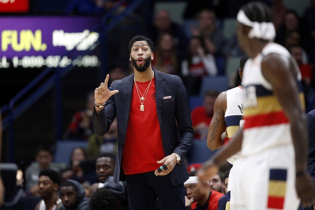 New Orleans Pelicans forward Anthony Davis talks to guard Jrue Holiday, foreground, in the second half of an NBA basketball game in New Orleans, Wednesday, Jan. 23, 2019. The Pistons won 98-94. (AP Photo/Gerald Herbert)