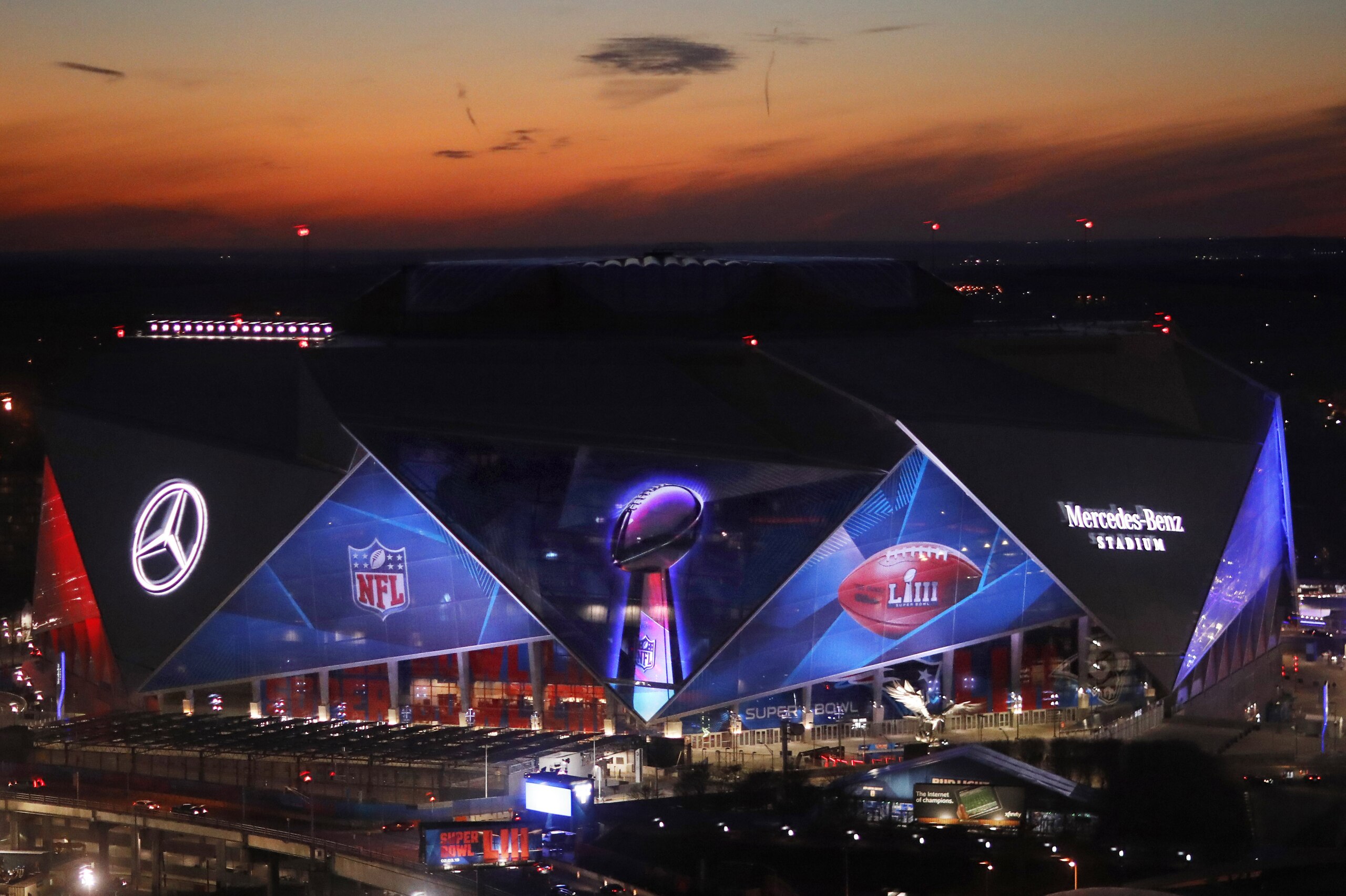 The sun sets behind Mercedes-Benz Stadium ahead of Sunday's NFL Super Bowl 53 football game between the Los Angeles Rams and New England Patriots in Atlanta, Wednesday, Jan. 30, 2019. (AP Photo/David Goldman)